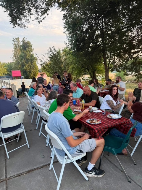 Mo'Licious BBQ catering event photo with guests and food